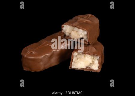 Three chocolate bars with one of them cut in half. The bars are stacked on top of each other Stock Photo