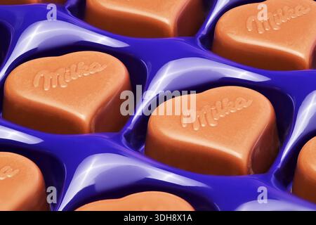 A close up of a box of Milka chocolates. The chocolates are heart shaped and are in a blue box Stock Photo
