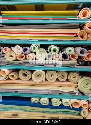 Yerevan Armenia 1.10.2026. A stack of colorful rolls of foam, including yellow, green, and pink. The rolls are piled on top of each other, creating a Stock Photo