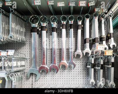 Yerevan Armenia 1.10.2026. A row of wrenches are hanging on a wall. The wrenches are of various sizes and are organized by type Stock Photo