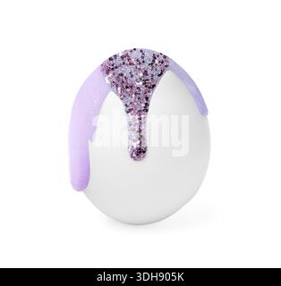 Paint with glitter dripping down egg on white background. Easter celebration Stock Photo