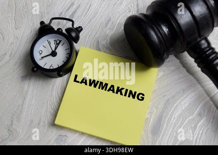 Concept of law making write on sticky notes isolated on Wooden Table. Legal authority, policy enforcement and decision making Stock Photo