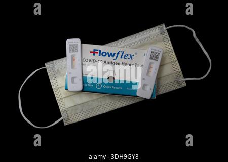 A positive and negative Covid-19 home test on a mask with a black background Stock Photo