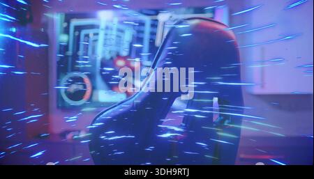 Framing racing-style gaming chair dominating home gaming room, monitor showing HUD, RGB fan glowing Stock Photo