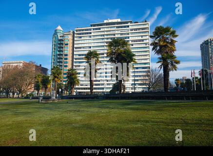 A row of palm trees in front of Ocean Towers apartment as seen from English Bay, Vancouver, BC. Stock Photo