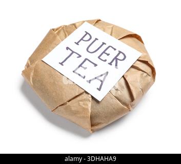 Dry pressed puer tea wrapped in paper and sticky note on white background Stock Photo
