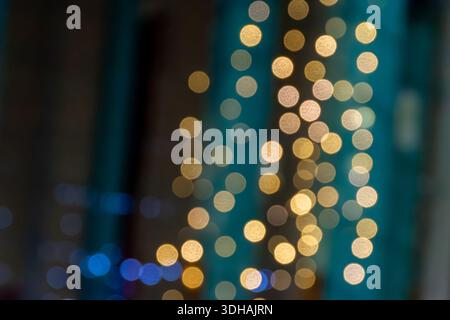 Soft glowing dots made from out-of-focus lights, this looks cozy and festive against green and brown stripes - perfect for social posts or decorations Stock Photo