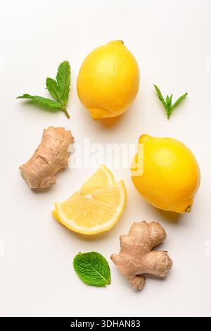 Fresh lemons with mint and ginger on white background Stock Photo