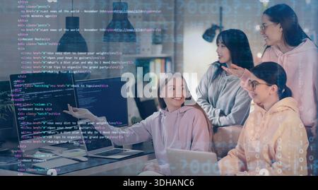 Group of female programmers working in office at night Stock Photo