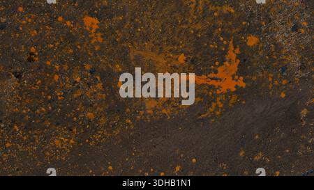 Grungy dark asphalt texture featuring vibrant yellow paint splatters. Weathered industrial urban background is ideal for edgy street-style designs and Stock Photo