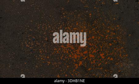 Grungy dark asphalt texture featuring vibrant yellow paint splatters. Weathered industrial urban background is ideal for edgy street-style designs and Stock Photo