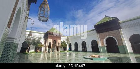 Grand mosque courtyard featuring a fountain and traditional islamic tilework under a blue sky.Habous quarter Stock Photo