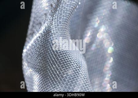 Abstract bright white mesh fabric texture close up with blur bokeh sparkle background creates elegant gentle soft mood and mysterious feeling for luxu Stock Photo