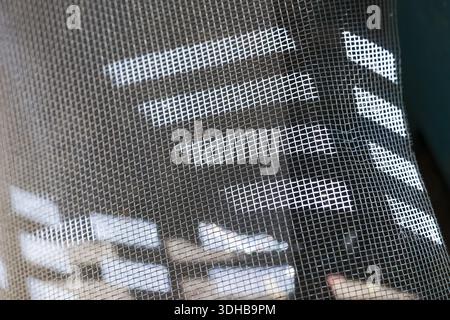 Active sporty mesh fabric texture with white geometric stripe patterns on dark black material showing breathable textile detail and modern athletic fa Stock Photo