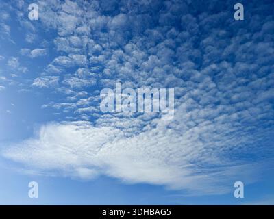 Altocumulus clouds in blue sky Stock Photo