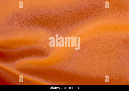 Closeup orange leather texture background abstract smooth surface pattern with wavy luxury bright color concept for fashion design elegant skin wallpa Stock Photo