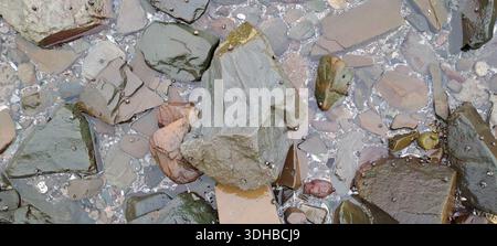 Smooth stones and pebbles submerged in clear water Stock Photo