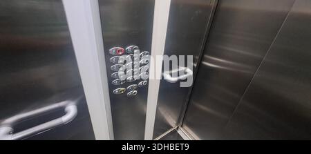 Elevator buttons illuminating floor numbers and open and close door buttons, inside a modern elevator Stock Photo