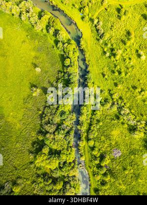 In the Weisspriach Valley, clear water flows through green trees and ...