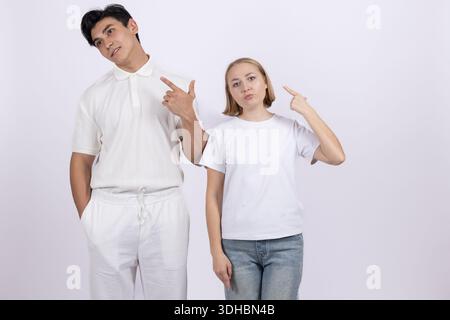 Young couple pointing at something to the side Stock Photo