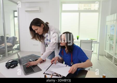 Medical professionals collaborating in a modern clinic during a busy workday Stock Photo