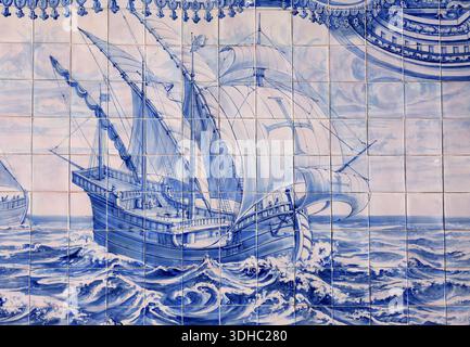 Portugal, Lisbon. Historic - ca 1775, blue and white, azulejo ceramic tile panel, depicting a Portuguese Caravel on one of the voyages of discovery. Stock Photo