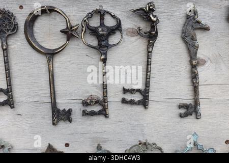 a collection of antique keys hanging on the wall Stock Photo