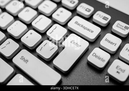 The Enter key and surrounding white keys of a modern computer keyboard. Stock Photo