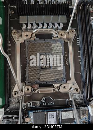 Close-up of CPU Socket on Motherboard with Heatsink and Cooling Pins Stock Photo