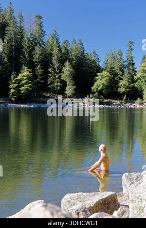 France, Vosges, Ballons des Vosges Regional Natural Park, La Bresse, Lac des Corbeaux, person doing yoga in the lake Stock Photo