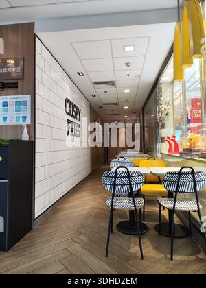 Modern McDonald's Interior with Patterned Chairs and Tile Wall Stock Photo