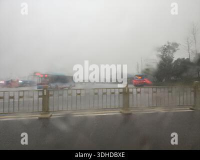 Rainy City Street View Through Wet Car Window Stock Photo