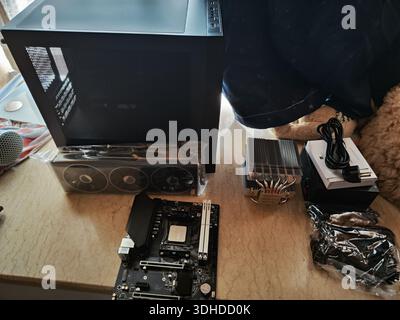 Components for building a custom PC on a workbench Stock Photo