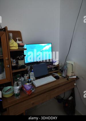 Home Office Desk Setup with Computer Monitor and Various Items Stock Photo