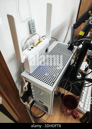 Wi-Fi router with cables on table Stock Photo - Alamy