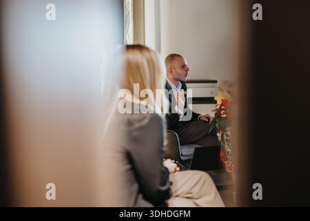 Professional man in a suit speaks during a business meeting in a modern office Stock Photo