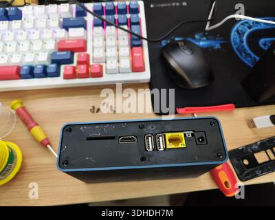 Top view of a compact computer with ports and tools on a desk Stock Photo
