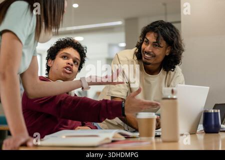 African American students studying and working in study area with laptop notebooks coffee bottle Stock Photo