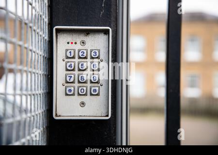 Detailed close-up of a keypad on the side of a residential car park gate, symbolizing security, access control, and property safety. Stock Photo