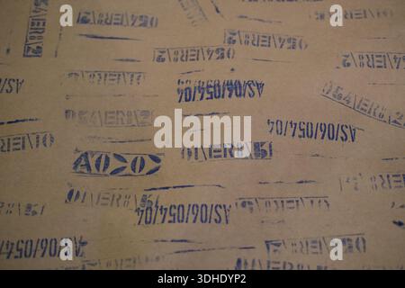 Close-up of silver measuring ruler displaying engraved numbers and tick marks, attached to a worn painted metal background with visible screws Stock Photo