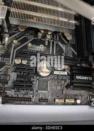 Close-up of Gigabyte motherboard with CPU cooler and components Stock Photo