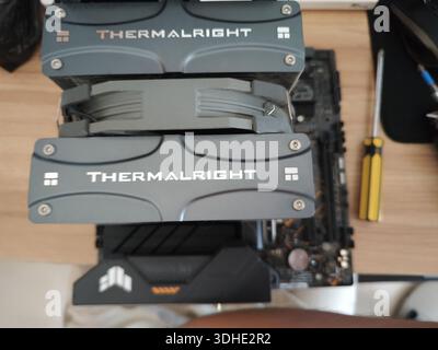 Thermalright CPU cooler installed on motherboard with screwdriver nearby Stock Photo