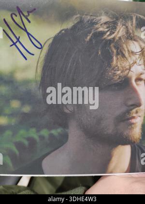 Signed portrait of a man with tousled hair and beard, outdoors in natural setting Stock Photo