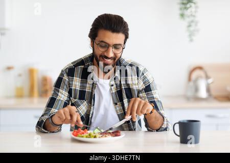 Positive arab guy having healthy breakfast at home Stock Photo