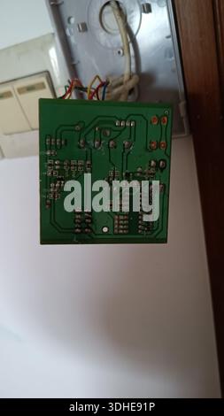 Close-up of a green printed circuit board with soldered components and wiring Stock Photo