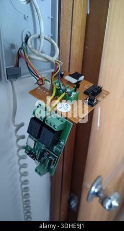 Electrical Circuit Board Mounted on Door Frame with Wires and Components Stock Photo