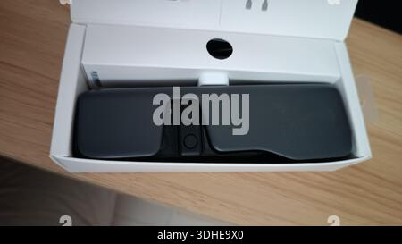 Compact Action Camera in Box on Wooden Surface Stock Photo