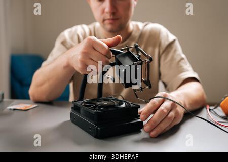 Technician performing maintenance and installation on sophisticated cooling system for computer cpu, ensuring efficient heat dissipation and enhanced Stock Photo