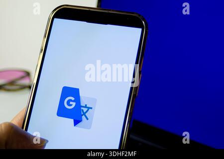 Smartphone screen showing google translate app icon, symbolizing instant multilingual translation, ai-powered language tools Stock Photo