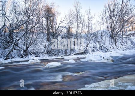 Icy River Rapids in Snowy Estonian Winter Landscape Stock Photo